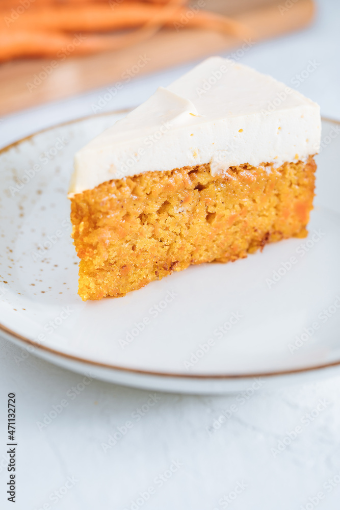 Carrot cake with cream cheese on top on a bright white backround Carrot cake with cream cheese on top on a bright white backround