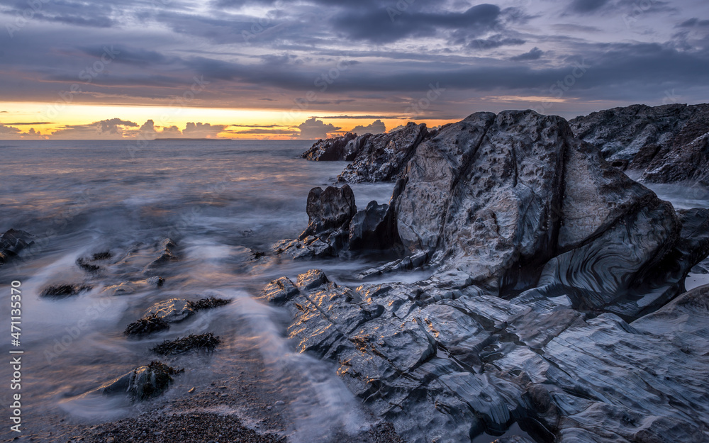 North Devon Sunset over Lundy Island and the low tide rocks at Woolacombe Beach