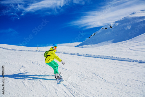 Girl snowboarder enjoys the winter ski resort.
