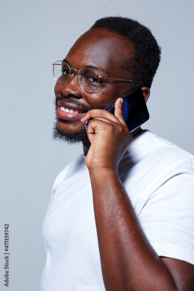 A businessman is talking on the phone while looking at camera. A businessman is talking on the phone while looking at camera.