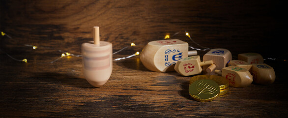 Jewish holiday Hanukkah with wooden dreidels, spinning top