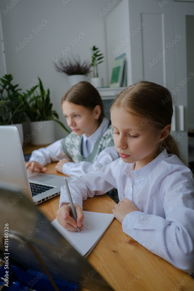 Two girls, sisters study at home, distance learning Two girls, sisters study at home, distance learning