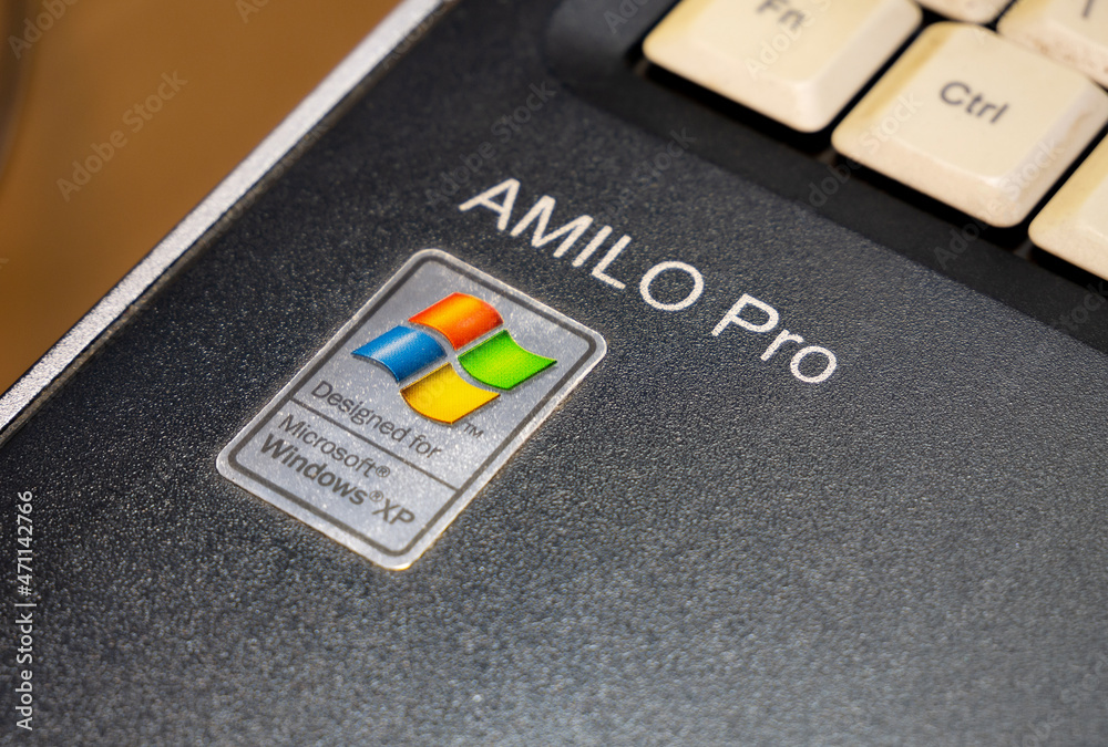 Foto Stock Designed for Microsoft Windows XP, Amilo Pro laptop, old netbook  outdated operating system sticker, retro computing concept. Object detail  closeup | Adobe Stock
