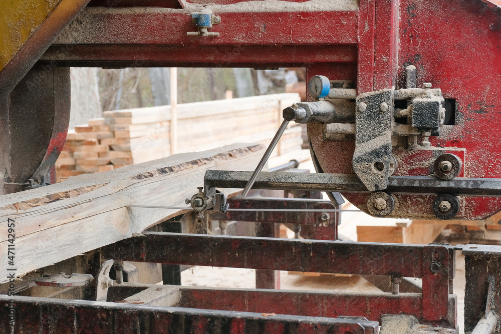 Processing wooden boards at a sawmill. Sawing logs