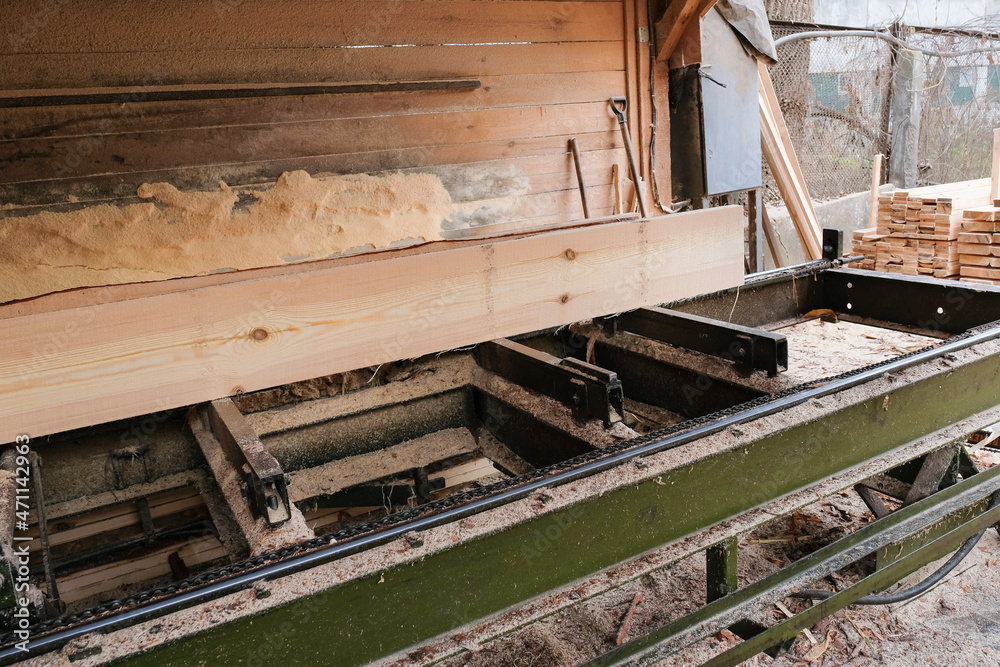 The process of processing logs and wooden planks on sawmill equipment. Timber industry. Sawing, drying wood The process of processing logs and wooden planks on sawmill equipment. Timber industry. Sawing, drying wood