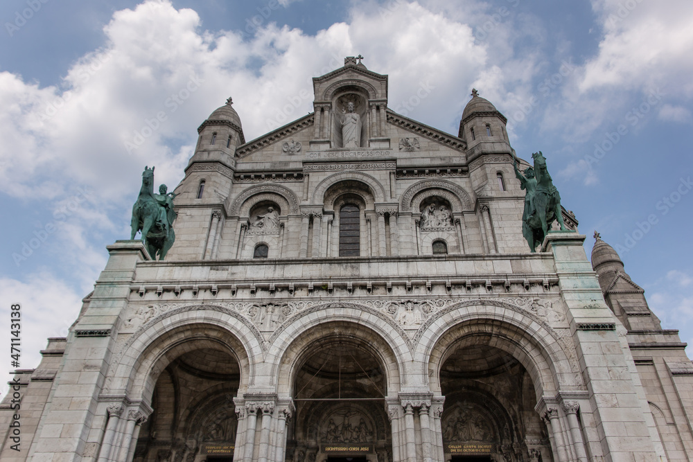 The entrance of the Sacre Coeur Basilica( Basilica of the sacred heart) with the two  bronze statues of King Saint Louis on the left and Saint Joan of Arc on the right. 