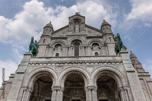 The entrance of the Sacre Coeur Basilica( Basilica of the sacred heart) with the two bronze statues of King Saint Louis on the left and Saint Joan of Arc on the right. 