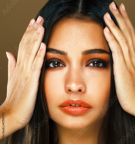 cute happy young indian woman in studio closeup smiling on brown background, fashion beauty lifestyle people concept