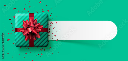 Green striped gift box with red bow and confetti.