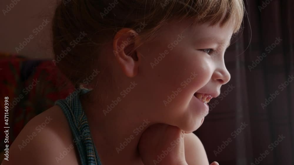 Happy cheerful young elementary school age child smiling, girl laughing, portrait up close, face closeup detail, real people lifestyle, indoors scene, children and true happiness concept, one person Happy cheerful young elementary school age child smiling, girl laughing, portrait up close, face closeup detail, real people lifestyle, indoors scene, children and true happiness concept, one person