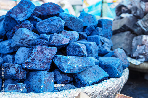 Blue indigo color stones displayed at traditional souk - street market in Marrakech, Morocco, closeup detail photo