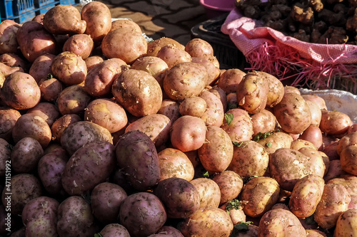 Sun shines on pile of potatoes displayed at street food market in Morocco