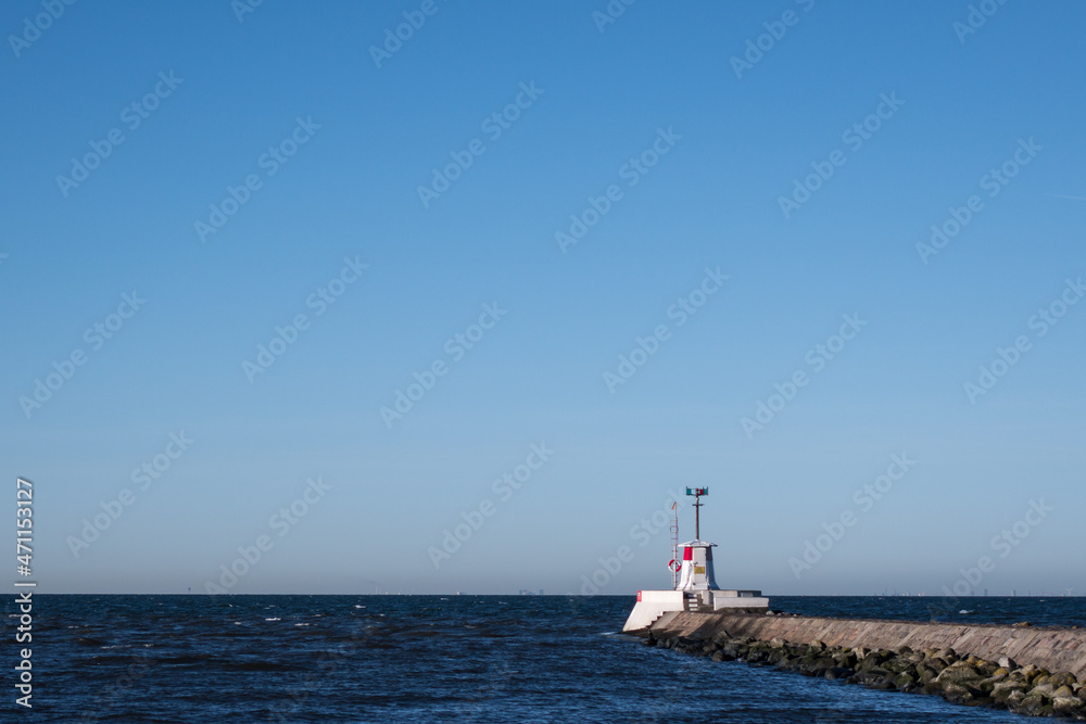 Lighthouse at end of pier by port entry