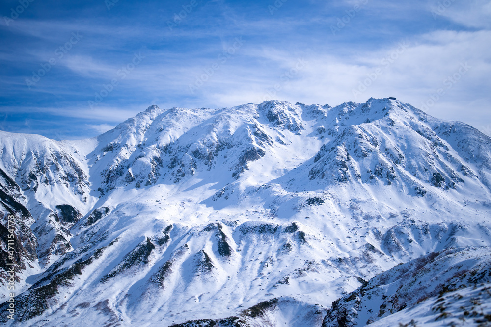 富山県立山町にある立山の冬の雪景色のある風景 Landscape with snowy winter scenery of Tateyama in Tateyama Town, Toyama Prefecture, Japan.