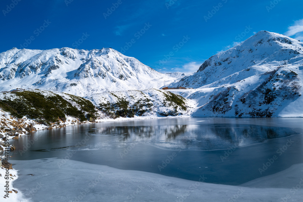 富山県立山町にある立山の冬の雪景色のある風景 Landscape with snowy winter scenery of Tateyama in Tateyama Town, Toyama Prefecture, Japan.