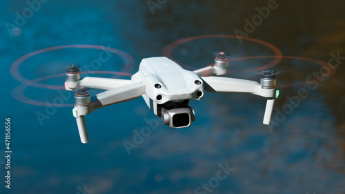 Drone. Professional drone with 5K camera for take a video, photo, film, movie footage. Aerial photography. Helicopter or copter flying over water. Flight technology. Wireless controlled drone.