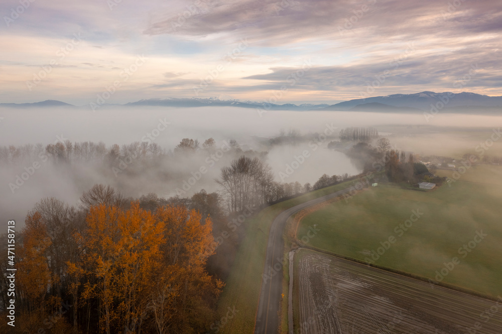 Fog Rolls in Over the Skagit Valley and the Skagit River on a Beautiful Autumn Morning. Aerial drone view of this magnificent area of western Washington state. Fog Rolls in Over the Skagit Valley and the Skagit River on a Beautiful Autumn Morning. Aerial drone view of this magnificent area of western Washington state.