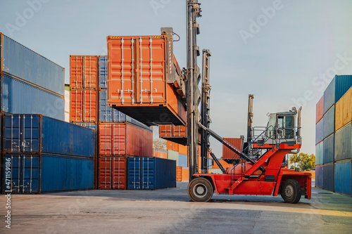In the shipping industry, a forklift truck raises cargo containers. 