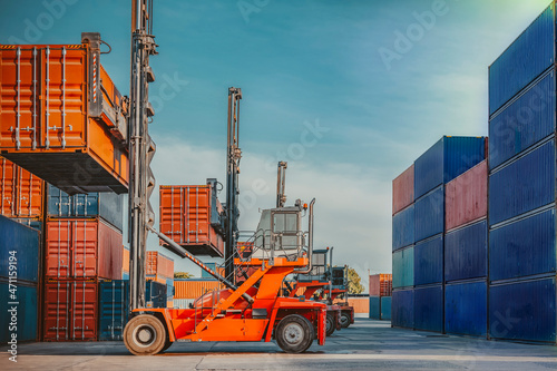 In the shipping industry, a forklift truck raises cargo containers. 