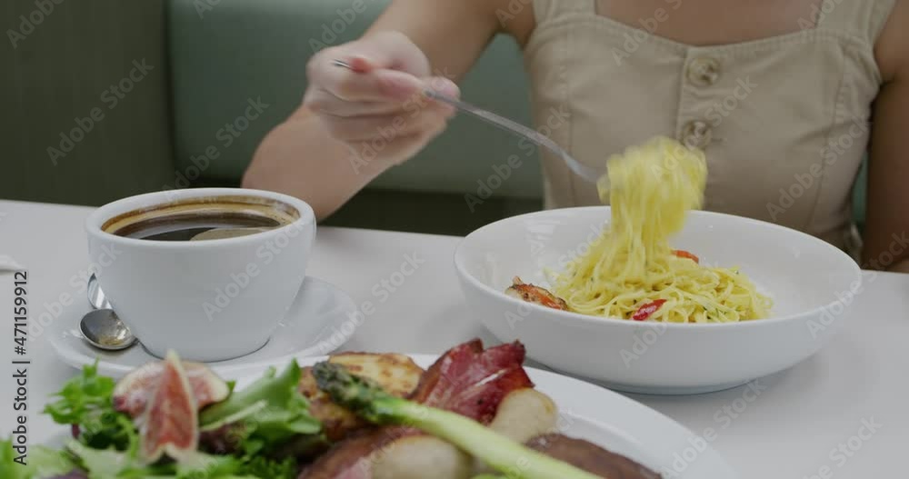 Woman enjoy pasta in coffee shop