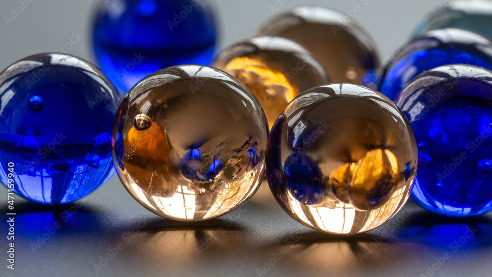 Lovely Amber and Blue Large glass crystal marbles in a row - stock photo.jpg Lovely Amber and Blue Large glass crystal marbles in a row - stock photo.jpg