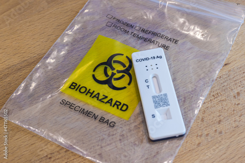 Cyberjaya, Malaysia - November 21, 2021: The latest Covid 19 spit test or quick test. Public places are only allowed if the visitor do a corona self test. After use the bag is classified  biohazard photo