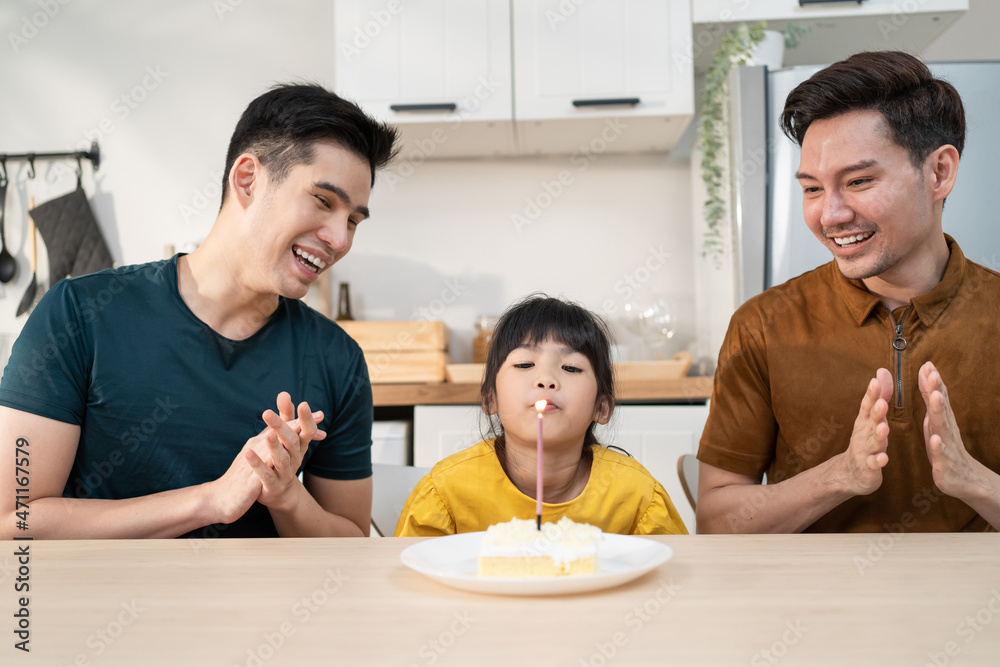 Asian attractive LGBTQ gay family celebrate birthday girl kid in house. 