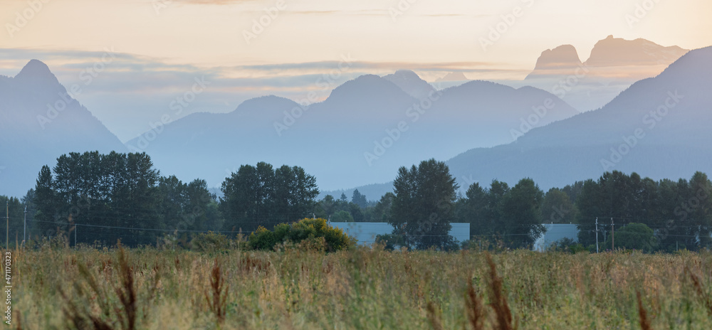 Distant mountains during morning light in British Columbia. A view of a valley with various layers of mountains