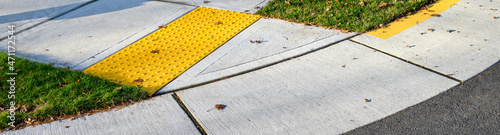 Canvastavla Closeup of disabled sidewalk entry on a cold sunny day, yellow markings
