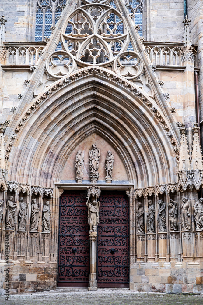 Gate at the entrance to Erfurt Cathedral and building facade in Germany