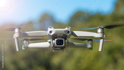 Drone. Professional drone with 5K camera for take a video, photo, film, movie footage. Aerial photography. Helicopter or copter flying in a forest. Flight technology. Wireless controlled drone.