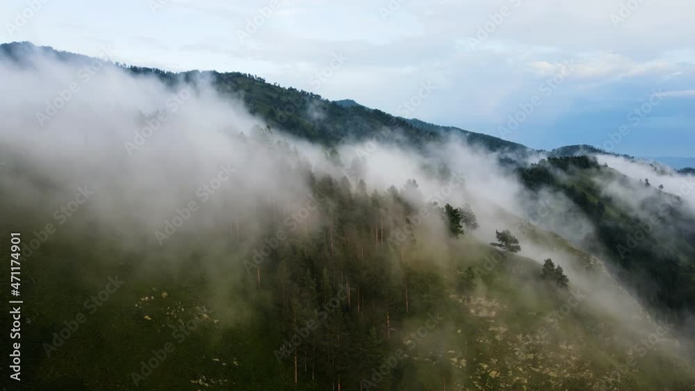 Clouds over the mountain range. Flyover over mountain clouds Clouds over the mountain range. Flyover over mountain clouds