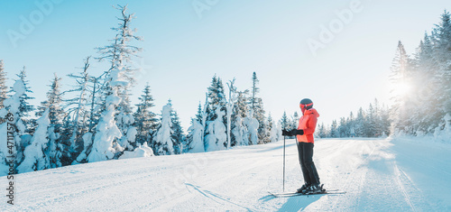 Принти на полотні Skiing woman skier looking at mountains landscape nature outdoors standing holding skis