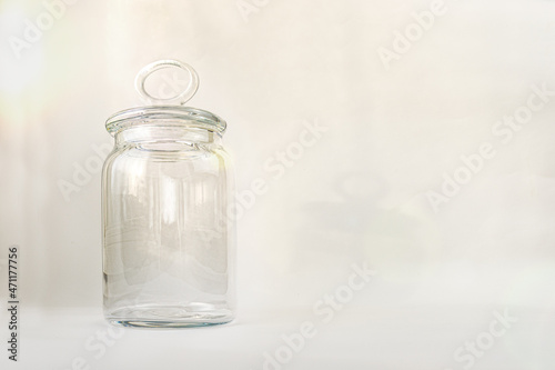 glass jar container with lapped lid on gray background. glassware. The texture of the stele. Containers for sweets and cereals 