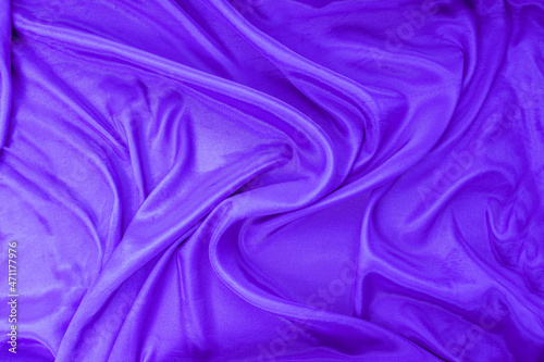 The texture of flowing lavender satin fabric. free space for your text. Canvas texture or background. texture and surface of the fabric. The background. bright colorful and rich fabric 