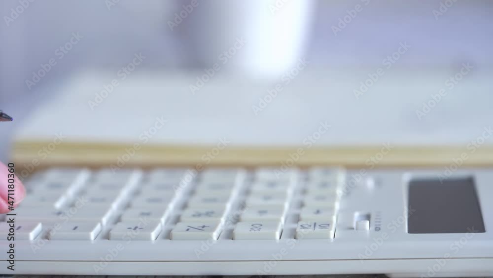 Close up of businessman busy paying bills calculating household finances or taxes on machine, manage home family expenditures, using calculator, make payment. Close up of businessman busy paying bills calculating household finances or taxes on machine, manage home family expenditures, using calculator, make payment.