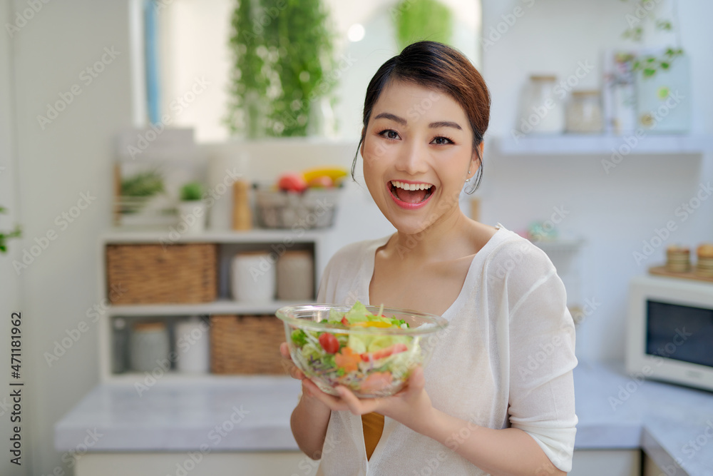Young beautiful woman eating fresh salad at home Young beautiful woman eating fresh salad at home
