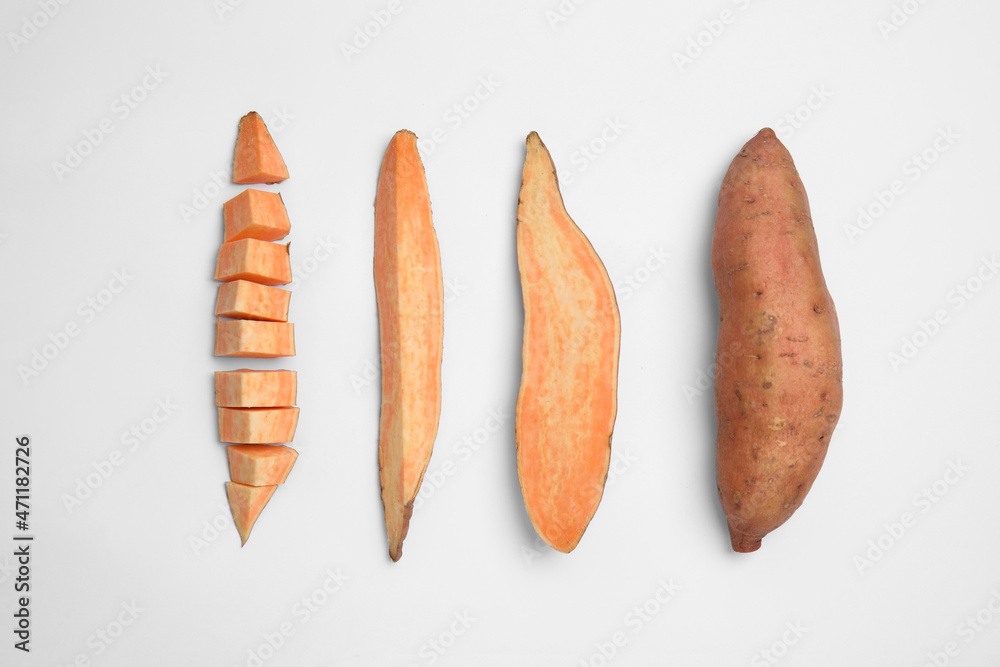Cut and whole sweet potatoes on white background, top view Cut and whole sweet potatoes on white background, top view