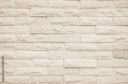 Cream and white brick wall texture background. Brickwork and stonework flooring interior rock old pattern uneven bricks design backdrop