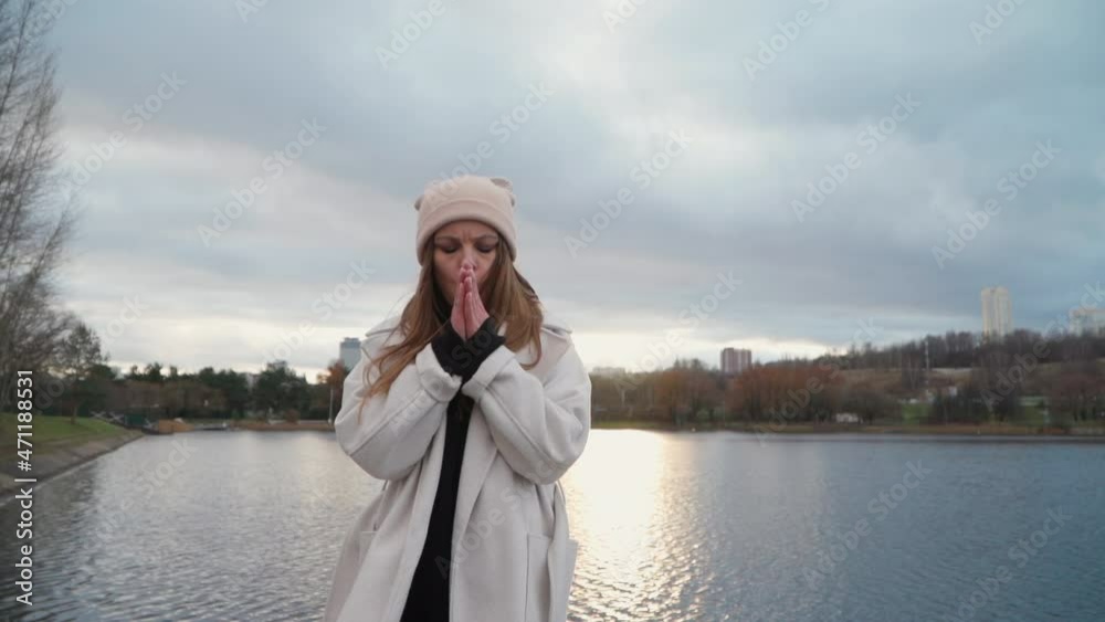 girl rubs her palms from the cold girl rubs her palms from the cold