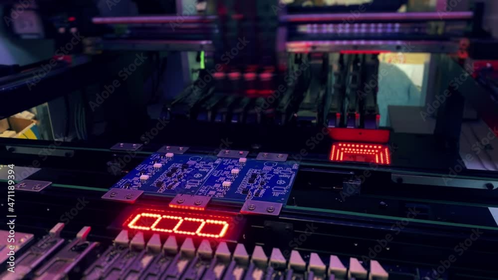 Automatic production of computer chips by SMT Pick and Place machine. Automatic SMT Pick and Place machine picks elements up and places them onto the motherboard. Automation of manual work.