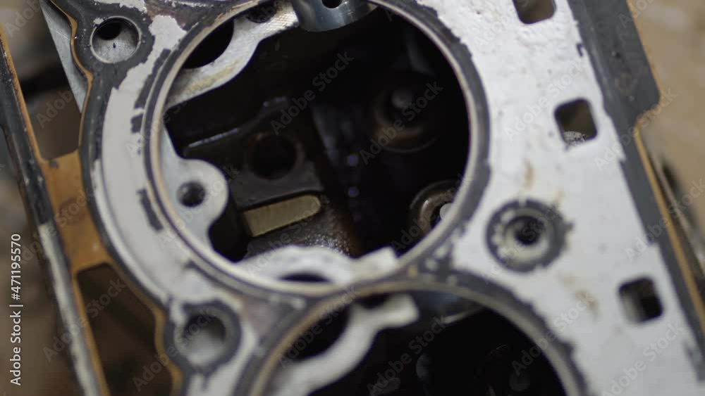 Mechanic service shop assembles the car engine and installs the cylinder head on the cylinder block Mechanic service shop assembles the car engine and installs the cylinder head on the cylinder block