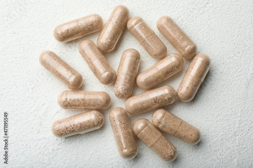 Gelatin capsules on white table, flat lay