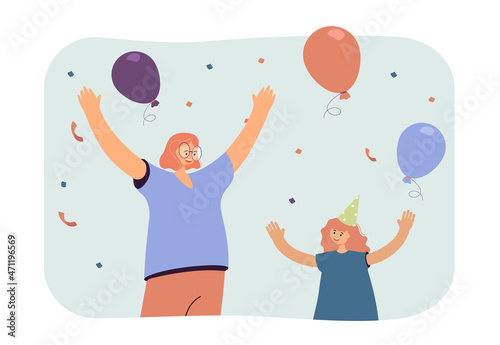 Cheerful mother and daughter with hands up celebrating birthday. Woman and child in party hat, balloons, confetti flat vector illustration. Family, love, celebration concept for banner, website design