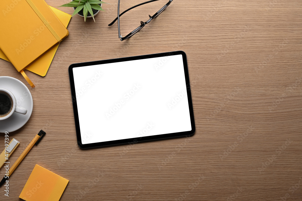 Top view mock up digial tablet, coffee cup and stationery on wooden table. Top view mock up digial tablet, coffee cup and stationery on wooden table.