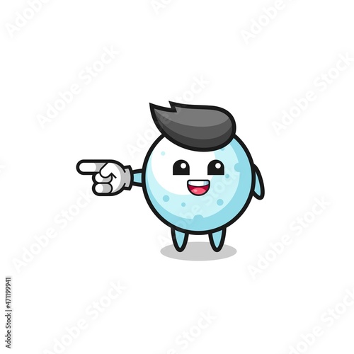 snow ball cartoon with pointing left gesture