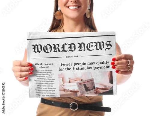 Young businesswoman holding newspaper on white background photo