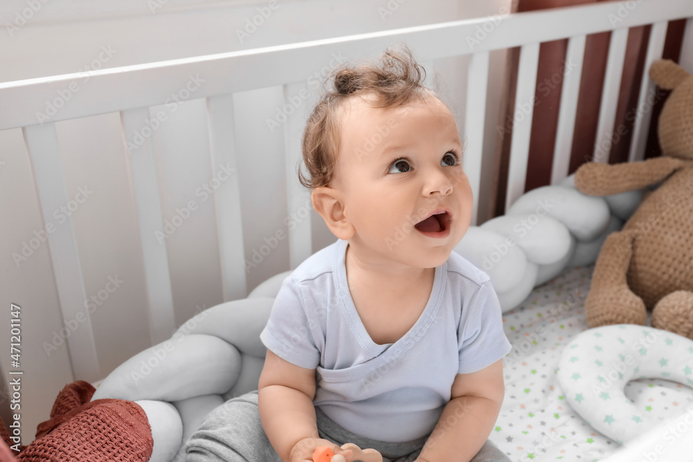 Cute little baby sitting in crib Cute little baby sitting in crib