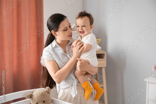 Young mother holding her li...
