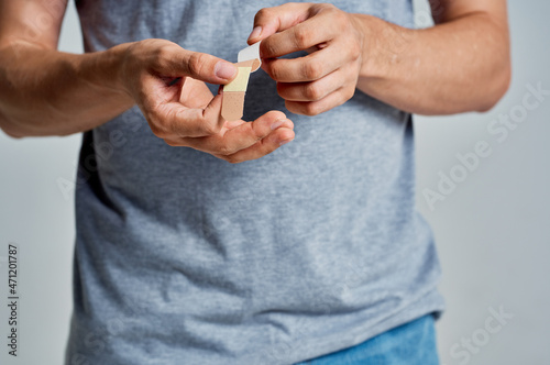man with a plaster on his finger injury treatment medicine